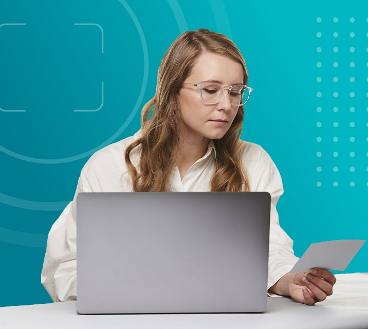 Woman checking her prescription to make sure the information matches.